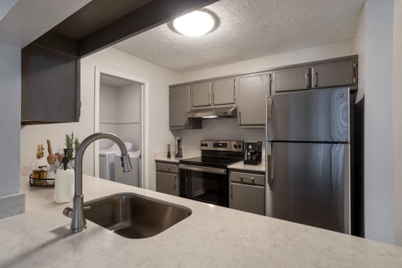 a kitchen with stainless steel appliances and granite counter tops at The Annaline, Nashville, TN