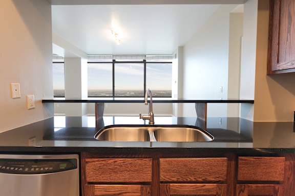 a kitchen with a sink and a window at Apartments at Denver Place, Denver, 80202