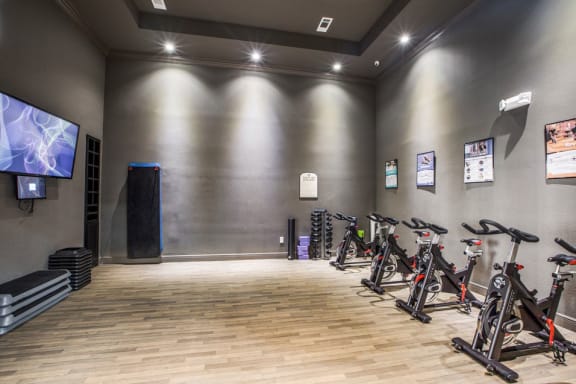 a room filled with bikes and a tv at Volare at the Woodlands, The Woodlands, 77384