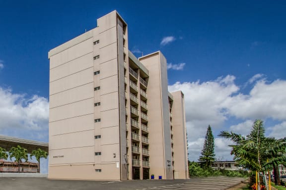 a large white building with a blue sky in the background at Waikele Towers Apartments, Waipahu, 96797