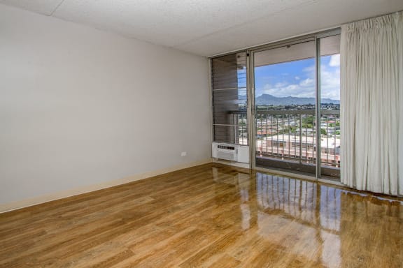 the living room of an apartment with a view of the city at Waikele Towers Apartments, Waipahu, HI 96797