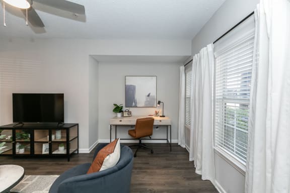 a living room with a couch and a desk with a tv at Willowest in Lindbergh, Atlanta, 30318