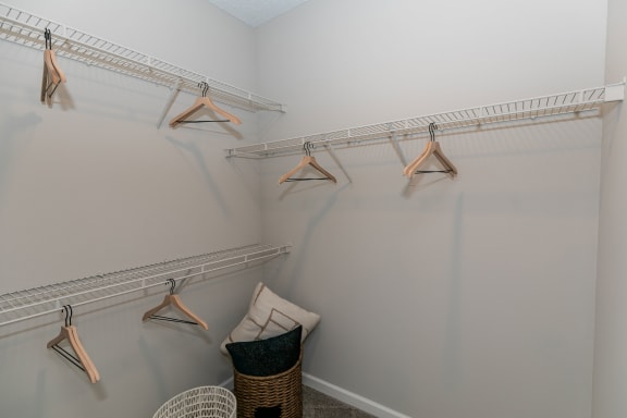two closets with clothes hangers and a chair in the corner of a room at Willowest in Lindbergh, Atlanta, GA, 30318