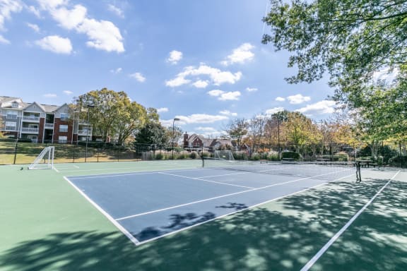 tennis courts with apartment buildings in the background at Roswell Village, Georgia, 30075