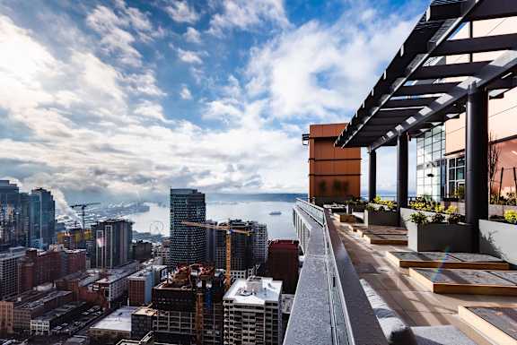 A cityscape with a clear sky and a view of the water.