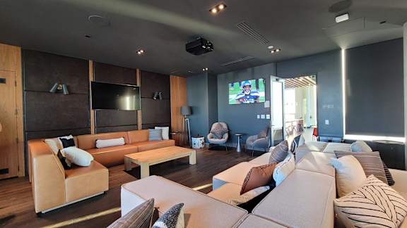 A modern living room with a large couch and a television.