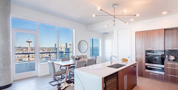 A modern kitchen with a view of the city.