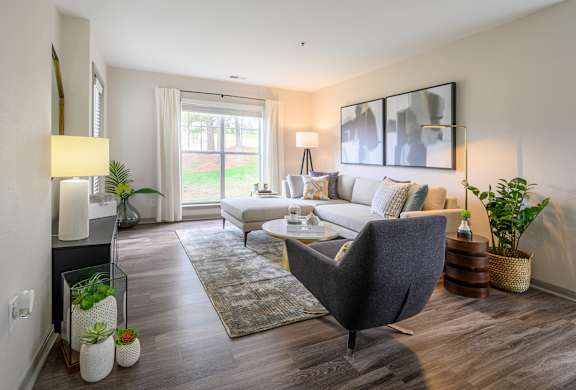a living room with a couch and a chair at Ashford Green, Charlotte