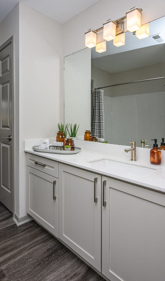 a white bathroom with two sinks and a mirror at Ashford Green, Charlotte