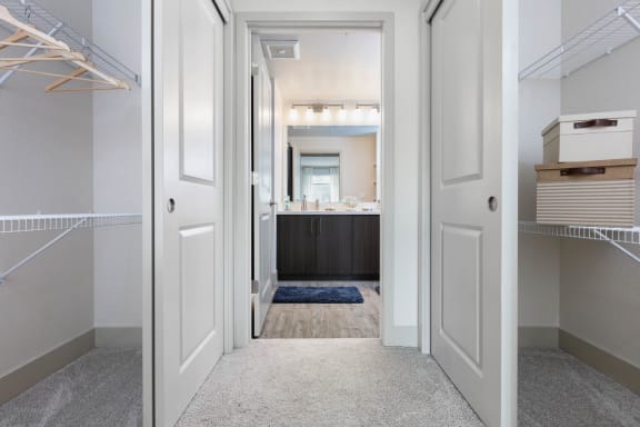 a master bedroom with a closet and a bathroom with a sink at Aventine, Hercules