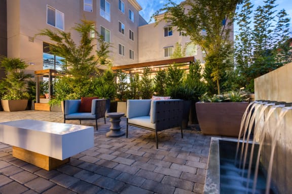 a patio with chairs and a waterfall at Aventine, California, 94547