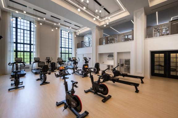 a gym with weights and exercise equipment in a large room  at The Belden Stratford, Chicago, Illinois