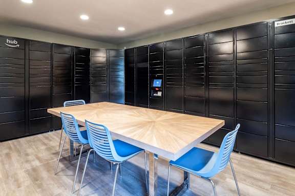 A conference room with a wooden table and blue chairs.