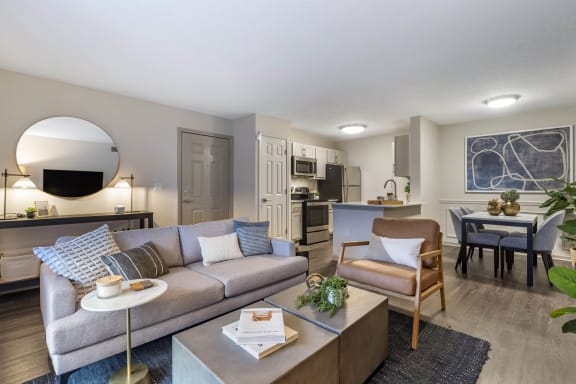 a living room with a couch and a table and a kitchen at Roswell Village, Georgia