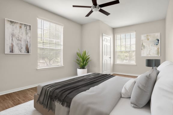 a bedroom with a bed and a ceiling fan at Veranda at Centerfield, Houston