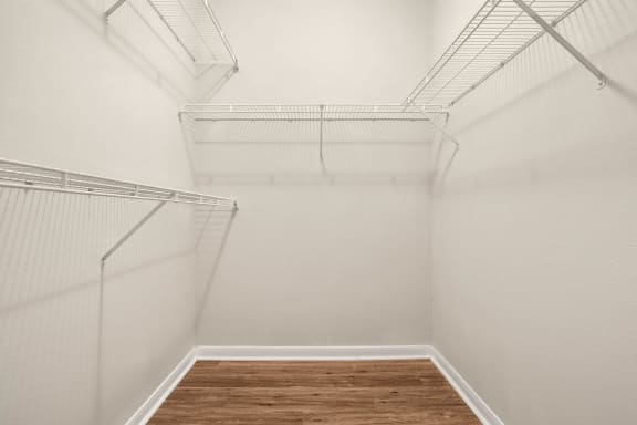 our spacious walk in closet with a wood floor and white walls at Veranda at Centerfield in Houston, Texas 77070