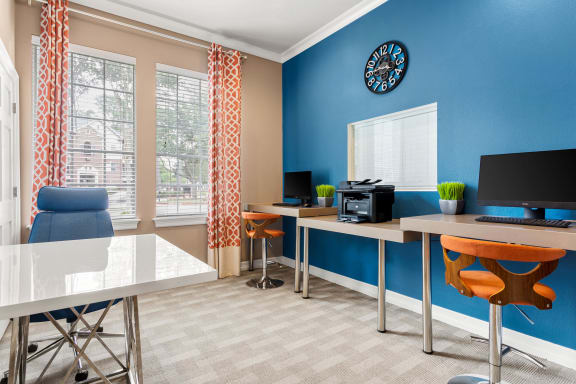 a room with a desk with a computer and a window at Villages of Cypress Creek, Houston