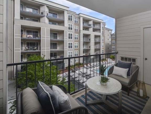 a balcony with a couch and a table at The Citizen at Shirlington Village, Virginia, 22206