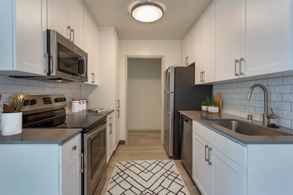 a kitchen with a sink and a refrigerator at Delphine on Diamond, California, 94131
