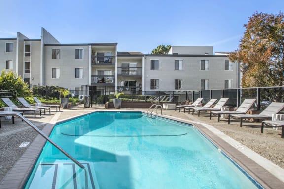 our apartments have a resort style pool with lounge chairs at Delphine on Diamond, California, 94131