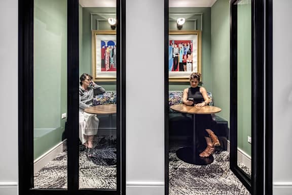 Two women sitting at a table  at Flair Tower Apartments, Chicago, 60654