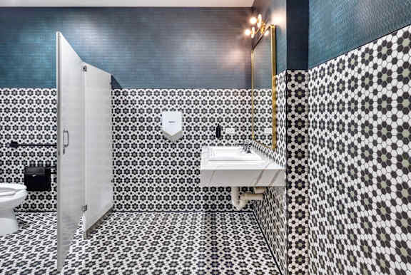 bathroom with a black and white tiled at Flair Tower Apartments, Chicago Illinois