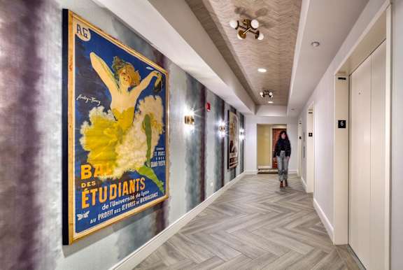 hallway with a vintage poster at Flair Tower Apartments, Chicago, IL 60654