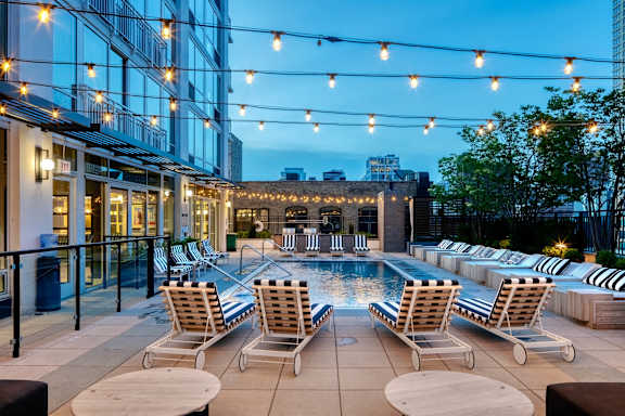 rooftop pool with string lights at Flair Tower Apartments, Illinois, 60654
