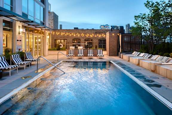 pool with a striped lounge at Flair Tower Apartments, Illinois