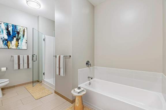 White bathroom with painting on wall at Flair Tower Apartments, Illinois, 60654