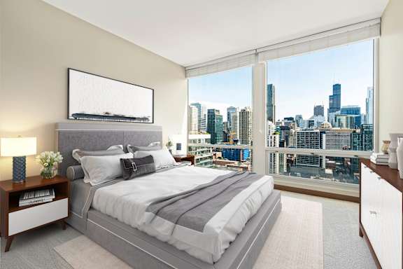 bedroom with a large bed at Flair Tower Apartments, Chicago