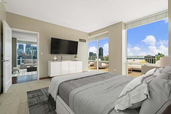 bedroom with a large screen TV at Flair Tower Apartments, Illinois