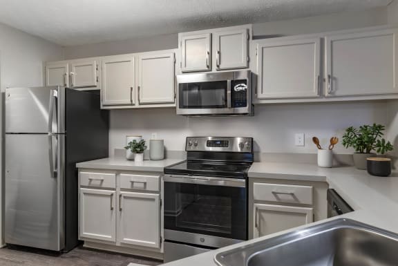 a kitchen with stainless steel appliances and white cabinets at Gwinnett Pointe, Georgia, 30093