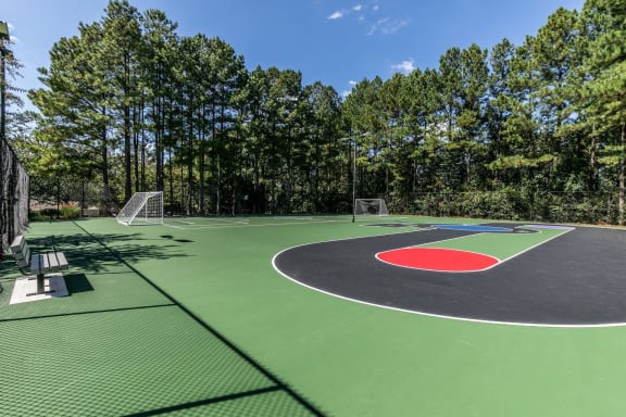 a basketball court at a park with trees in the background at Gwinnett Pointe, Georgia, 30093