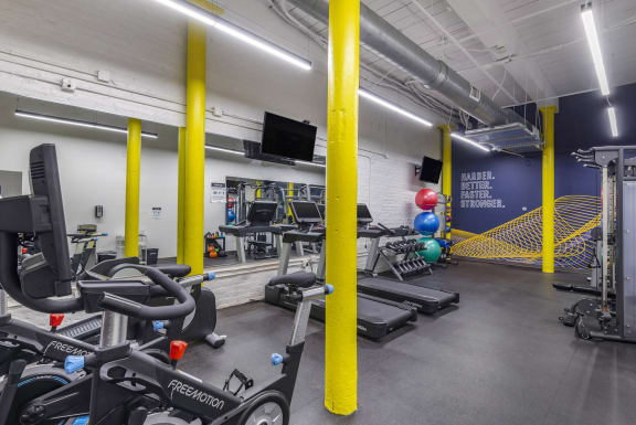 a gym with cardio equipment and weights in a building at Highland Mill Lofts, Charlotte, NC