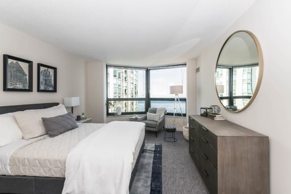 a bedroom with a large bed and a large window at North Harbor Tower, Chicago, IL