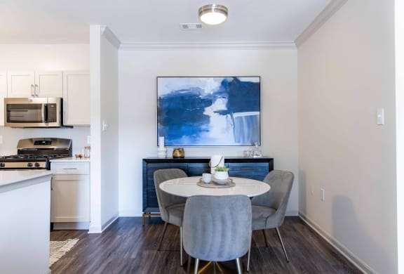 a dining room with a table and chairs and a kitchen at The Residences at Springfield Station, Springfield