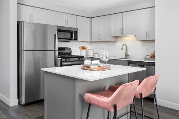 a kitchen and living room in a 555 waverly unit at Shoreham and Tides, Chicago, IL