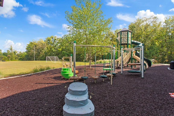 a playground with a slide and other toys in a park at The Annaline, Nashville, TN, 37217