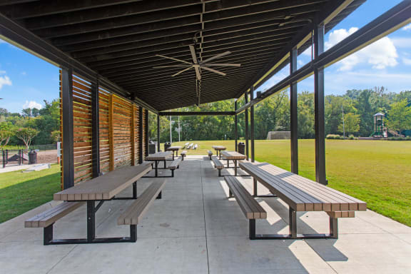 a row of picnic tables under a covered pavilion at The Annaline, Nashville