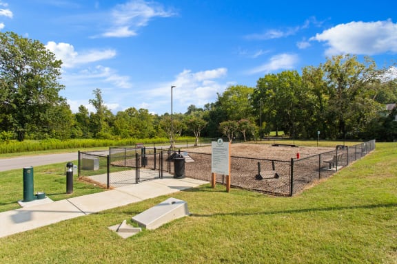 a dog park with a chain link fence and a sign at The Annaline, Nashville, TN