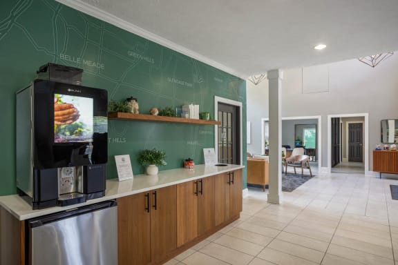 a kitchen with a coffee machine and a green wall at The Annaline, Nashville, Tennessee