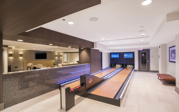 a bowling alley in the lobby of a hotel with bowling lanes at The Elle Apartments, Chicago, Illinois