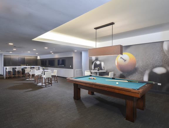 a pool table in a room with tables and chairs at The Montrose, Chicago, Illinois 60613