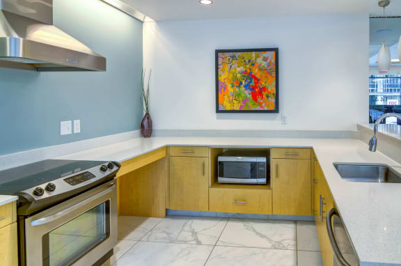 Kitchen with marble look flooring and efficient appliances with a flame hood at The Parker Apartments, Oregon