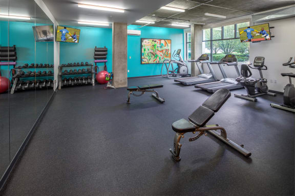 a fitness room with treadmills and other exercise equipment at The Parker Apartments, Oregon