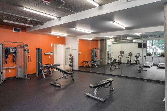 a large fitness room with weights and cardio equipment at The Parker Apartments, Oregon, 97209