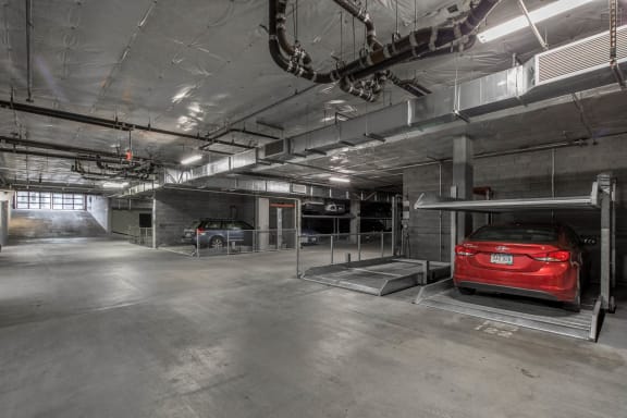 a red car parked in a parking garage at The Parker Apartments, Portland, Oregon