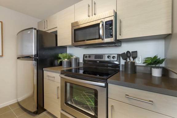 a kitchen with stainless steel appliances and a microwave at Vue, San Pedro, CA