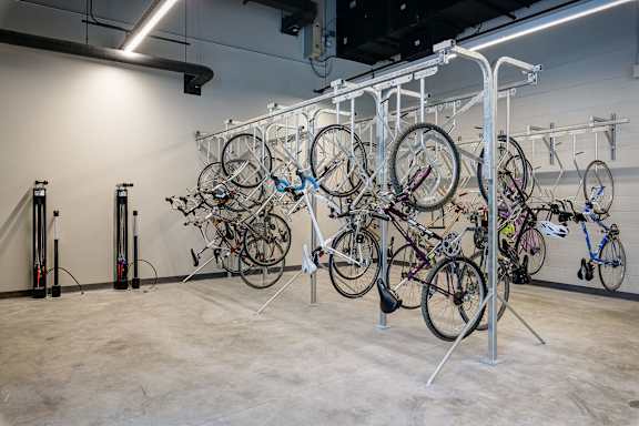 A bike rack with many bikes hanging on it. at The Mason Apartments, Chicago